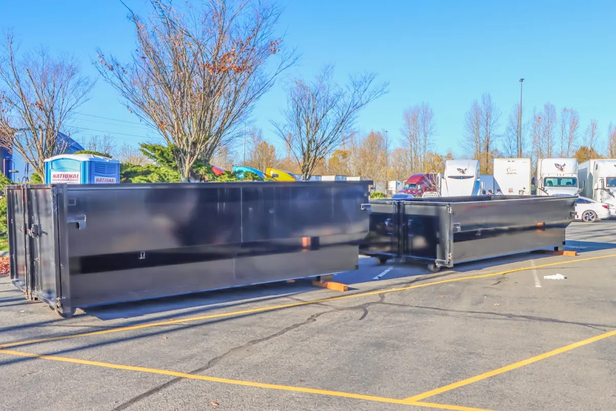 Professional dumpster rental service with roll-off container on residential driveway in Urbana